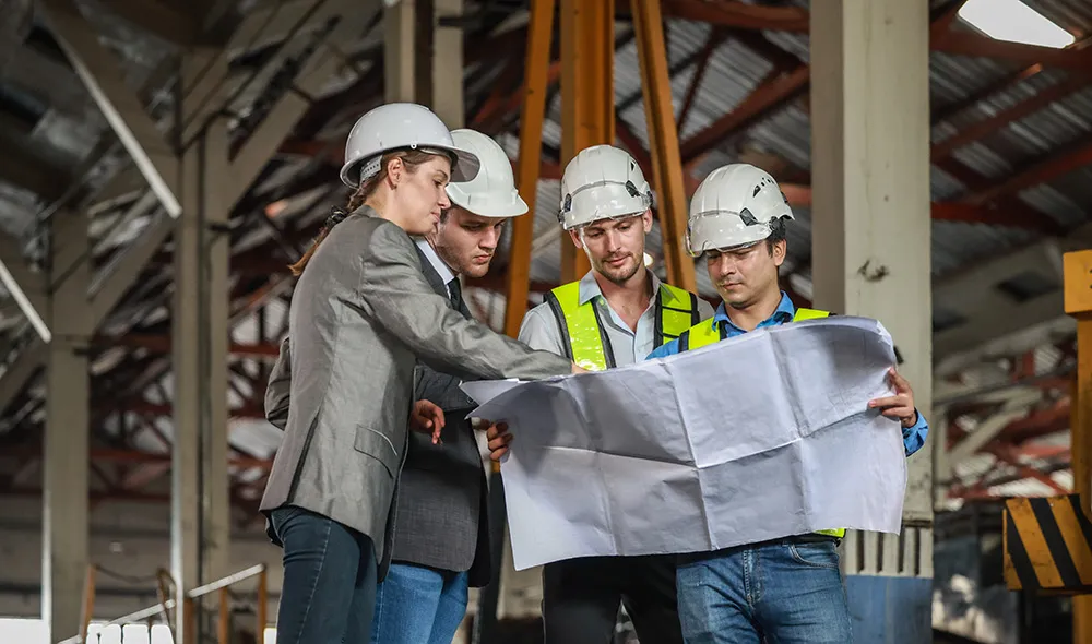 Contractor team reviewing plans on NY jobsite